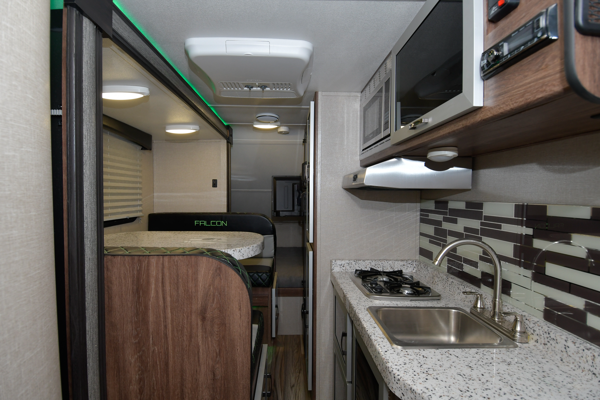 The Falcon GT galley features a molded Granicote fiberglass countertop with stainless steel sink and a two-burner cooktop.