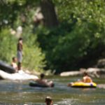 Boy tubing down Creek