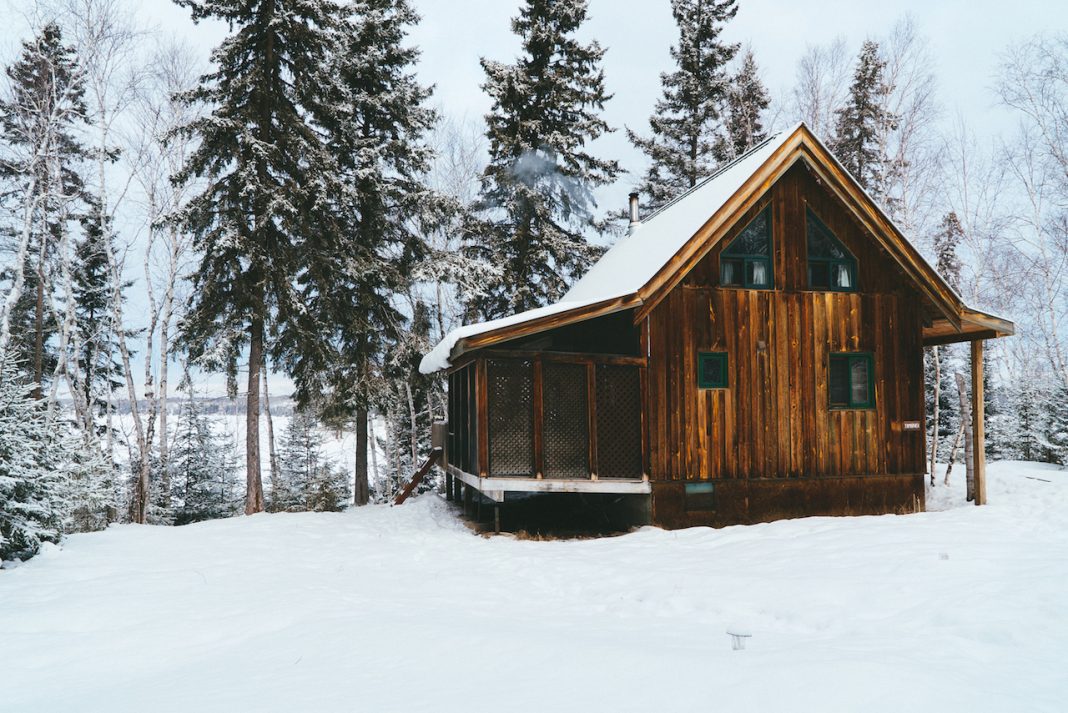 A snowy cabin in Manitoba along a lake in Whiteshell Provincial Park