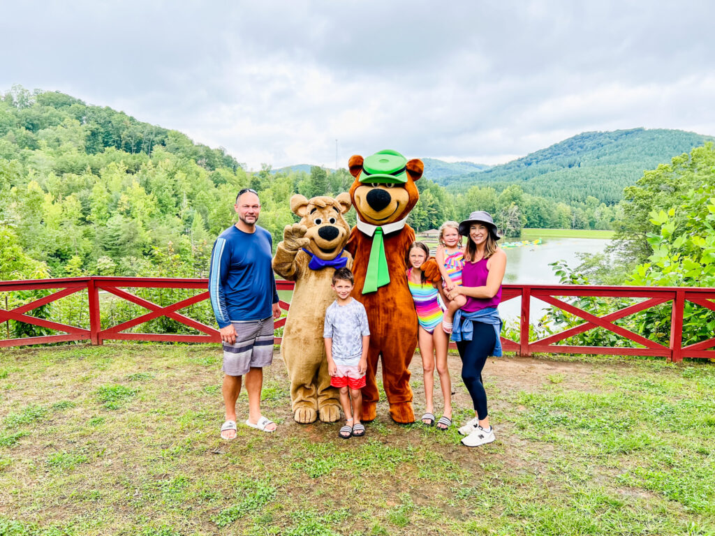 Yogi Bear and campers enjoying a family camping adventure