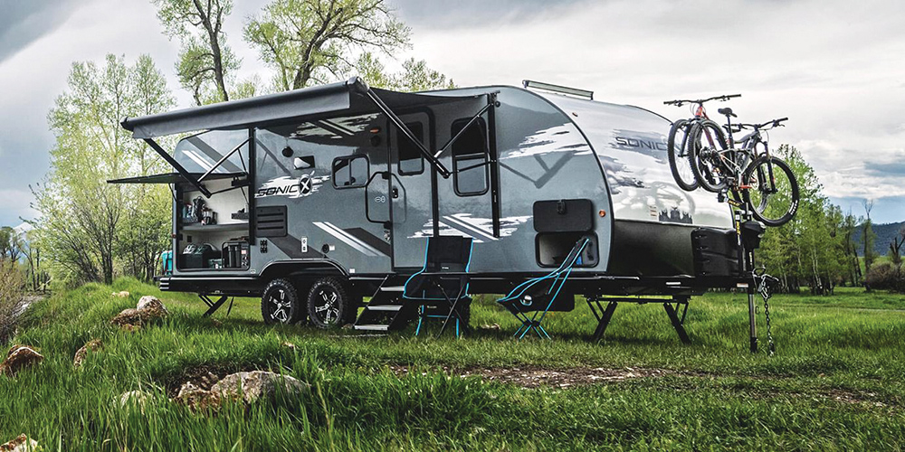 https://www.rvlifemag.com/wp-content/uploads/2023/05/web-2023-Venture-RV-Sonic-X-SN220VRBX-Travel-Trailer-at-Campsite.jpg