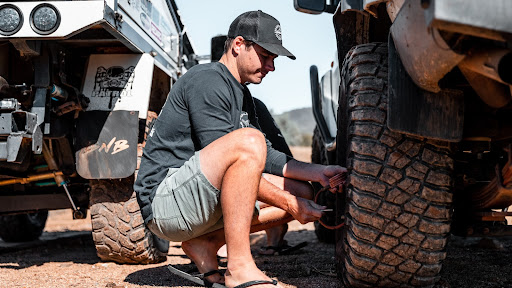 Fixing a flat tire on a 4x4 off-road vehicle.
