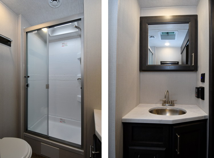 The Cougar 25MLE has a spacious bathroom with shower stall, vanity, sink, and medicine cabinet.