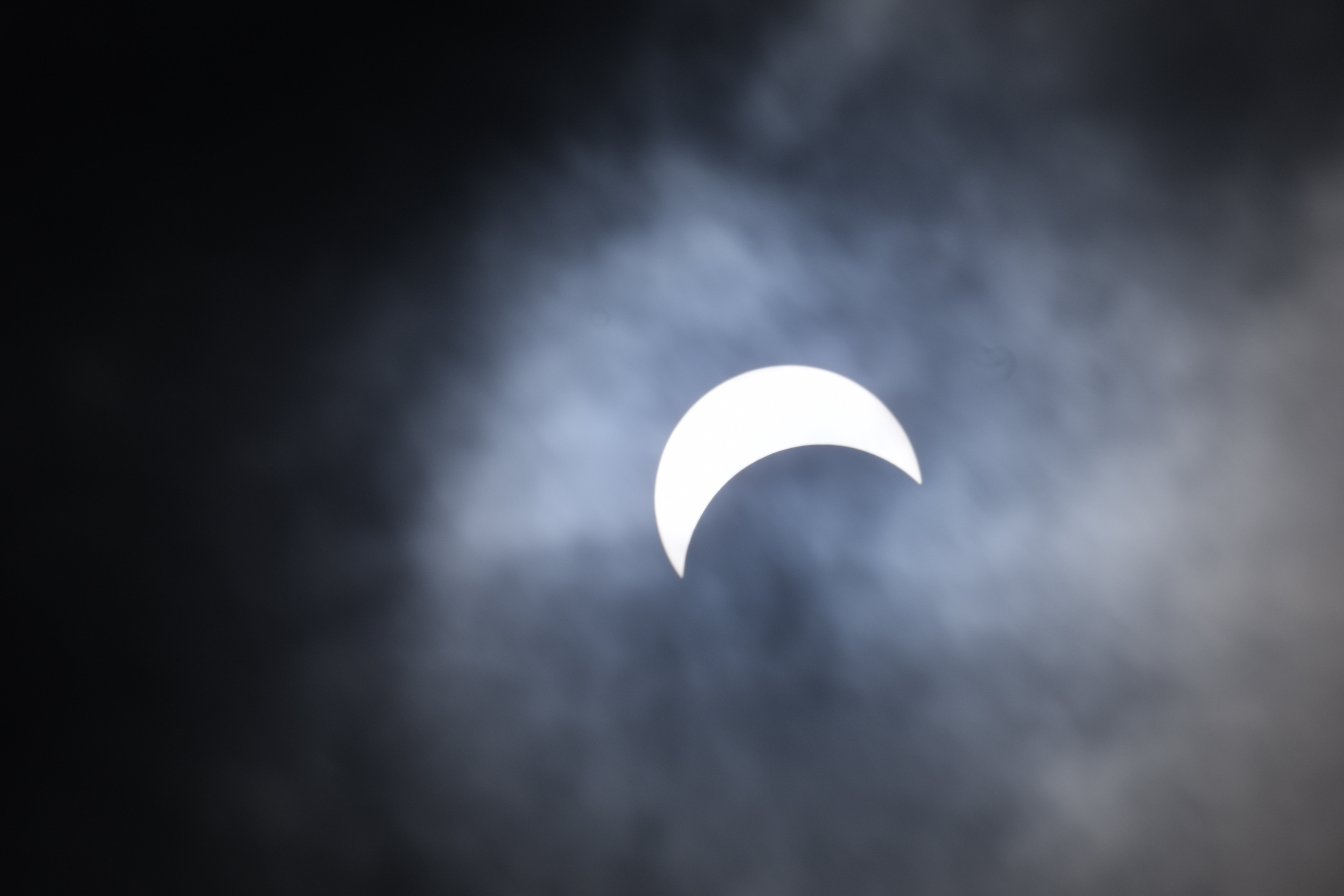 After a tense period waiting for the sky to clear, the solar eclipse broke through the clouds over Beamsville, Ontario at 2:50 pm April 8 2024. Norm Rosen photo.