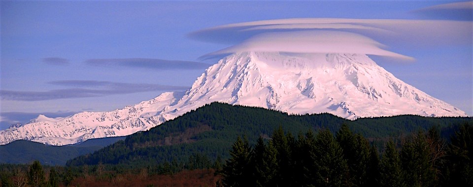 Lenticular, disc-shaped, clouds cling to the peak of Mount Rainier. Photo credit: NPS/Steve Redman
