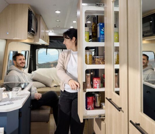 Roadtrek 2025 Play + model interior showing galley pantry and rear lounge in dinette mode.