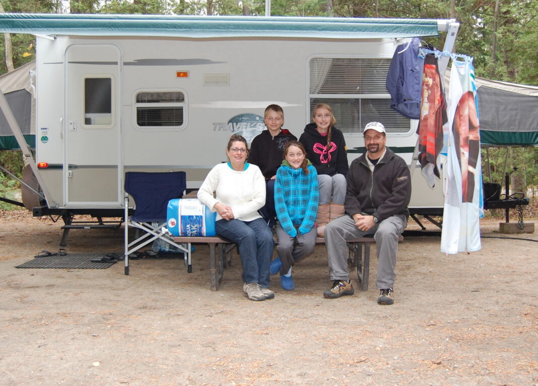 The Coles family with their first travel trailer. Photo by Cheryl Coles.