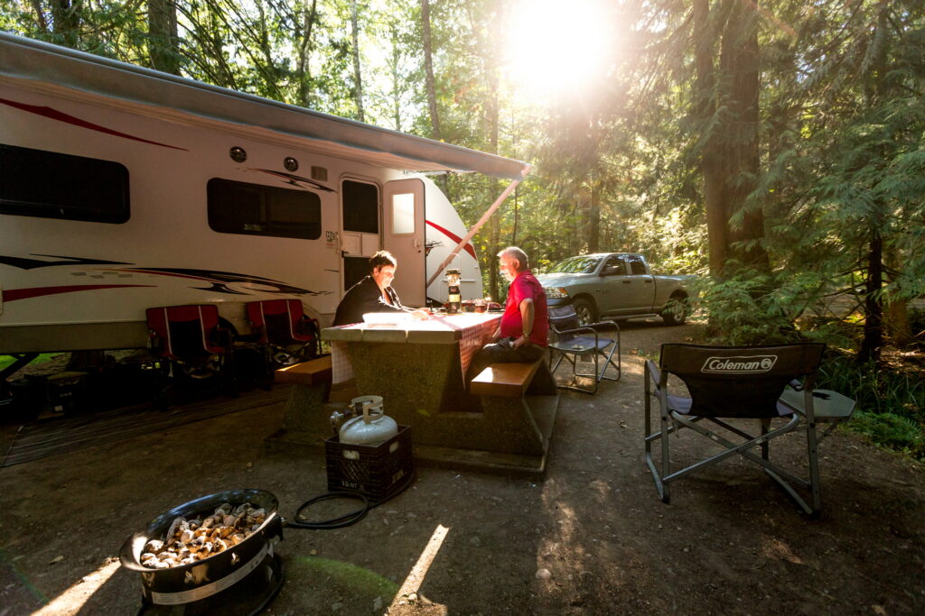A couple relaxing outside their RV,
surrounded by the lush forest at Prior
Centennial campground on Pender Island. Gulf Islands National Park
Reserve, BC. Photo
© Parks Canada / Fritz
Mueller