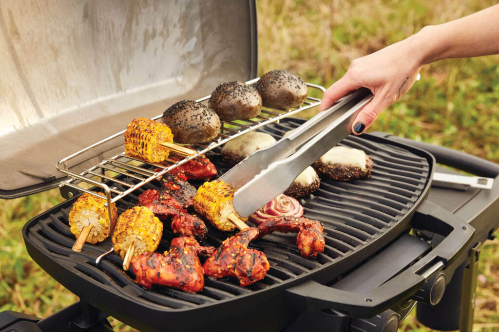 The Napoleon Phantom TravelQ™ Portable Gas Grill features a high top lid and two stainless steel burners to take portable grilling to the gourmet level. Barbecue up to 17 hamburgers or roast succulent turkeys, whole chickens, and even prime rib. The included warming rack with an innovative hinge design allows the rack to flip back when not in use to provide full access to the main cooking grids.